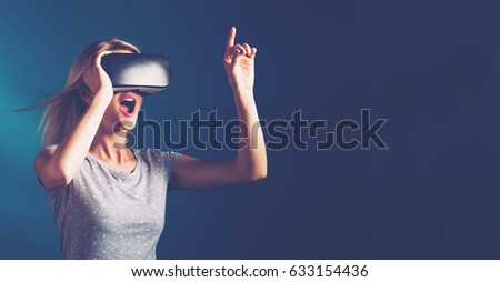 Happy young woman using a virtual reality headset