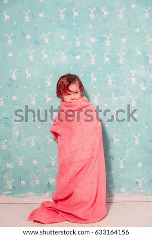 The child is wrapped in a towel.
