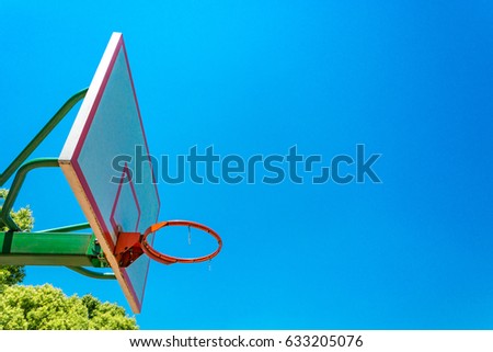 basketball hoop and backboard with blue sky