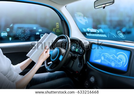 cockpit of autonomous car. a vehicle running self driving mode and a woman driver reading book. Royalty-Free Stock Photo #633216668