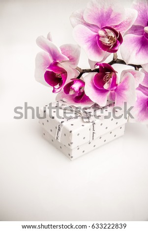 Gift box on a background of purple orchids