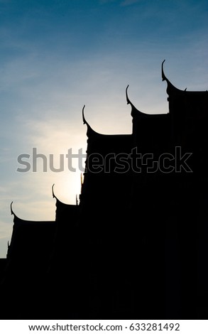 Close up silhouette buddha temple roof in Bangkok with blue sky, vertical picture, religious tourism attraction in Thailand