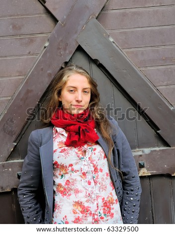 Outdoor portrait young woman with wooden door