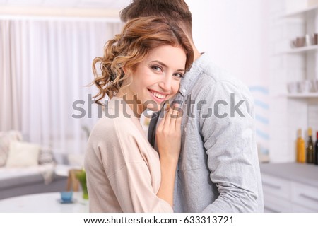 Cute happy young couple at home