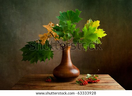 Still Life Autumn concept image with maple leafs and berries