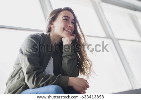 A nice and cool Teenager girl sitting on window