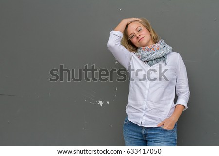outdoor portrait of young happy girl on neutral urban wall background