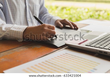 freelance artist graphic designer using digital tablet, computer, creative man working with color swatch palette catalog samples for selection - Creativity Editor Ideas Designer Concept