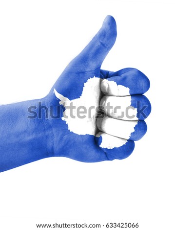 Hand making thumbs up sign. Antarctic painted with flag as symbol of thumbs like,up,okay. Isolated on white background.