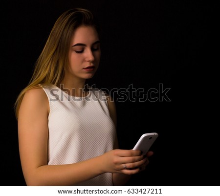Pretty young girl uses smartphone