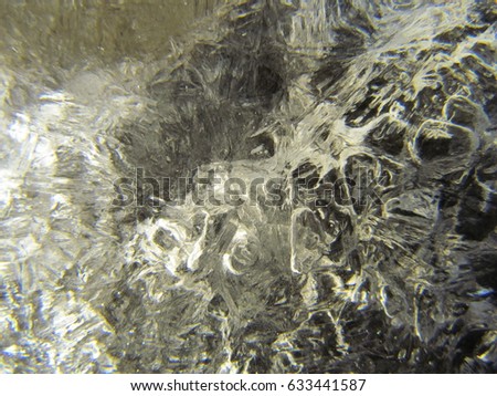 Beautiful macro photography of ice nuggets clamped together giving the picture a painting effect.