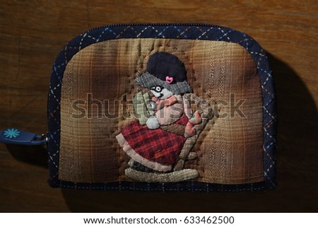 Quilting product. Wallet old woman pattern of quilt. Homemade Japanese quilt. Japanese handcraft. Signed property release. Selective focus and toned image.