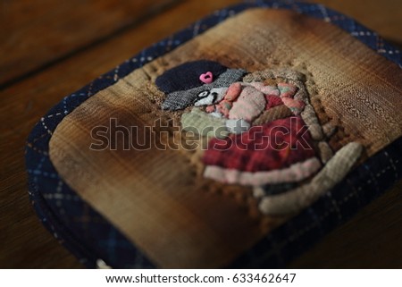 Quilting product. Wallet old woman pattern of quilt. Homemade Japanese quilt. Japanese handcraft. Signed property release. Selective focus and toned image.