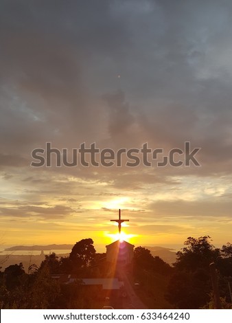 Silhouette of cross during sunset
