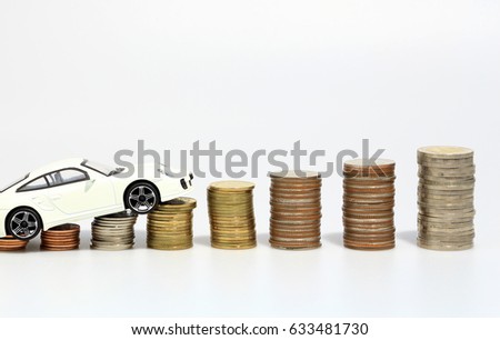 White car on money coins stacked, white background.