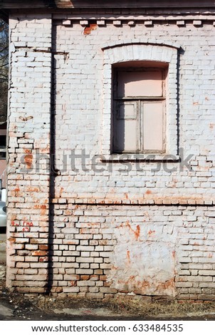 The window of the old brick building covered with board, grunge background