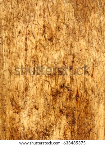 Backgrounds and textures: surface of aged wooden board with dings, dents and stains