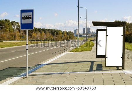 Bus stop on a high-speed  highway near to a mega city. Solar autumn day.