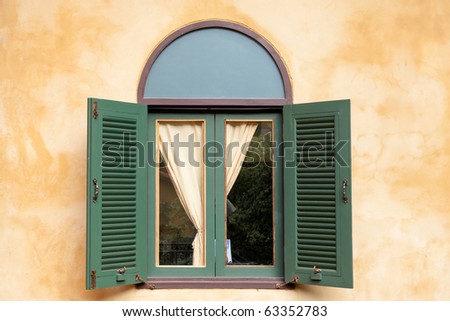 Italian window with yellow wall Royalty-Free Stock Photo #63352783