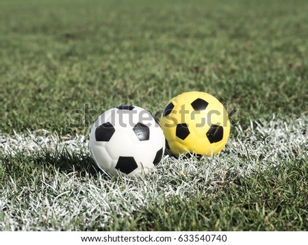 Soccer ball in green field in corner line