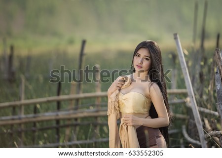 country girl portrait in outdoors,beautiful happy Asian girl smile and laugh together,Happy rural girl smiling in field,portrait of a happy young asian girl.
