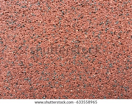 Concrete wall with brick-red pebbles for use as background