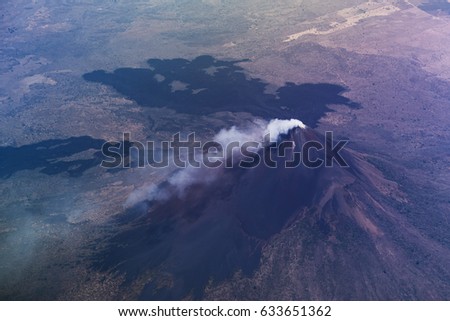 Volcano with smoke in crater aerial view. Momotombo volcano in nicaragua landscape