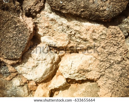 Closeup detail of grungy aged stone cement cracked textured backdrop, rough background image