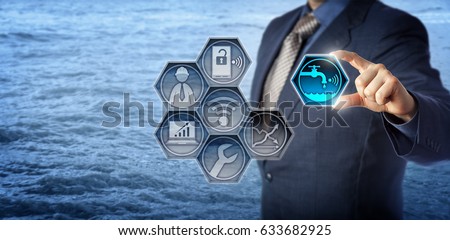 Blue chip civil engineer plugging a smart water metering icon into a virtual monitoring app. Concept for water resource management, water efficiency, environmental engineering and water conservation. Royalty-Free Stock Photo #633682925