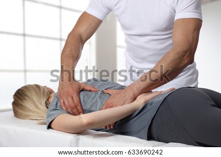 Woman having chiropractic back adjustment. Osteopathy, Acupressure, Alternative medicine, pain relief concept. Physiotherapy, sport injury rehabilitation Royalty-Free Stock Photo #633690242
