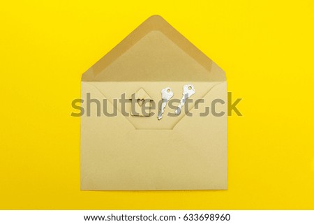 Paper postal envelope and wooden house with keys, concept.