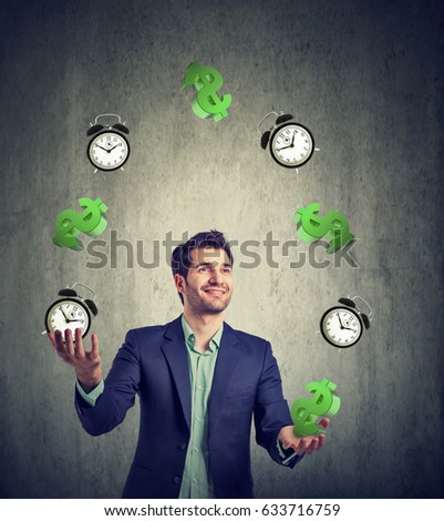 Time is money concept. Happy young businessman juggling dollar signs and alarm clock 
