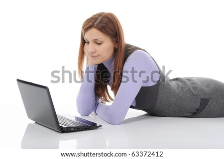 Brunette woman with laptop lying on the floor in a bright room. Isolated on white background