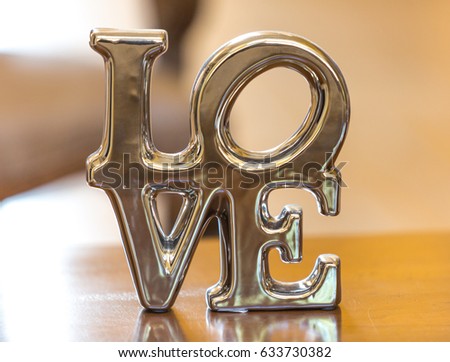  word "love" on a metallic porcelain sign