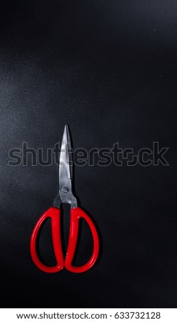 Vertical shooting Household scissors in black background