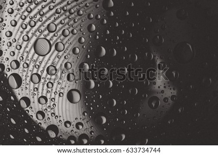 Abstract lines through drops of water on a glass, macro view