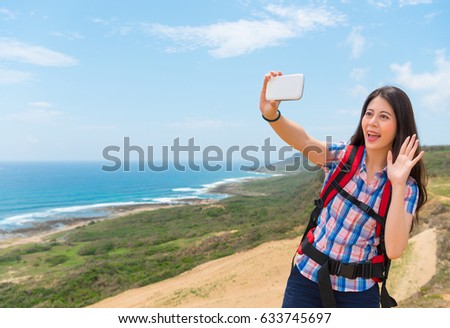 beautiful woman in coastal hill mountain with family and friends through online app video to chat and happy make hello gestures share joy in holidays.