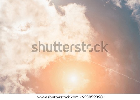 Trace of an airplane in a sunny sky with fluffy clouds