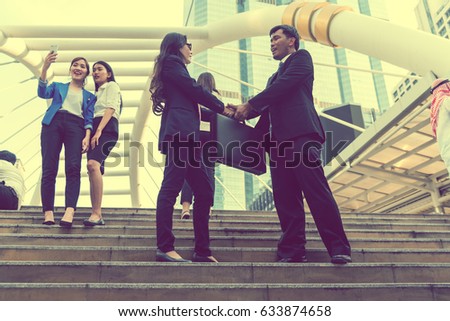 vintage toned,Team of business people talking and Shaking Hands outdoor office,modern building in city