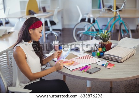 High angle view of businesswoman working at desk in creative office
