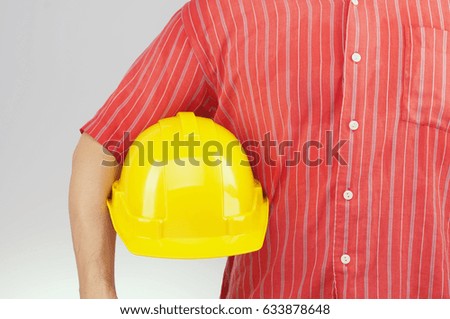 Engineer man have yellow skin with red shirt hold yellow engineer hat on white background. Industrial with people successful concept photography.