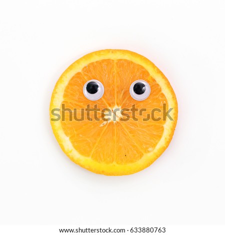Funny food concept. Funny cartoon eyes on orange isolated on white background. 
