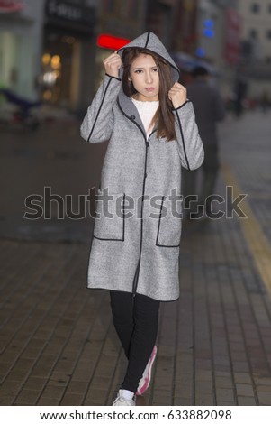 Beautiful young woman on twilight street