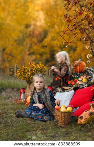 Two girls with pigtails are walking and having fun in the autumn park. Childhood friendship. Children laugh and play outdoor. Sisters or girlfriends. Look at the camera
