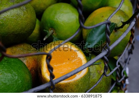 green fresh oranges in the basket