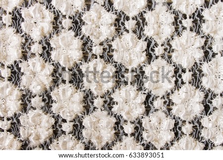 White Flower Knitting Pattern on Black Fabric Texture Background. Knitting background or knitted texture background