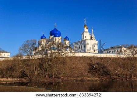 White-stone monastery with sky-blue domes at early morning