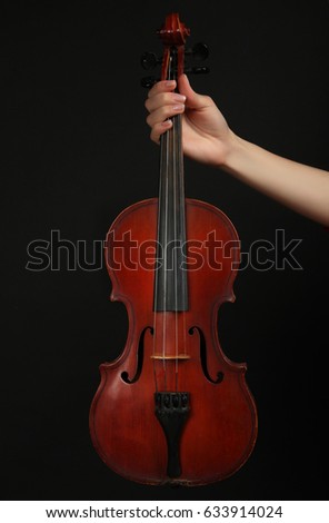 Stringed bow musical instrument, violin on a black background