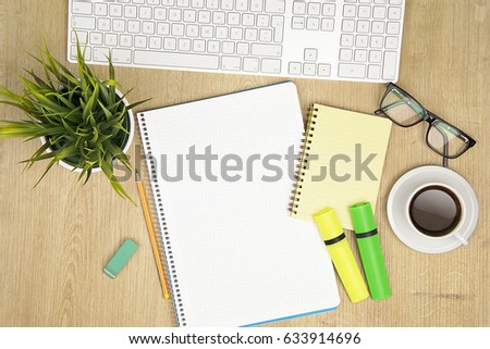 Notepaper, pencil and computer keyboard
