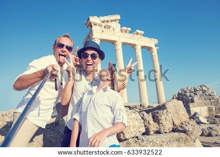 Funny family take a selfie photo on Apollo Temple colonnade view in Side, Turkey